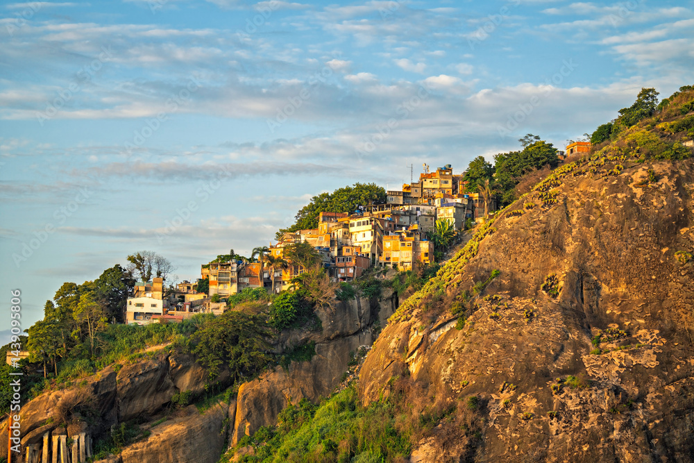 Obraz premium Typical favela buildings on the steep hill at sunrise in Rio de Janeiro, Brazil