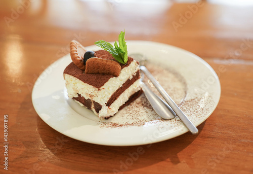 Obraz na płótnie Tiramisu cake with mint leaf on wooden table w salonie