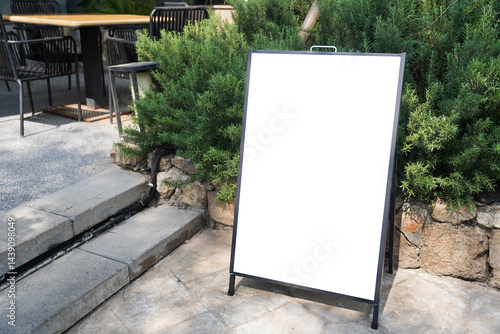 Obraz na płótnie Blank white outdoor advertising stand sandwich board mock up template. Clear street signage board placed by an outdoor dinning area of a restaurant.. w salonie