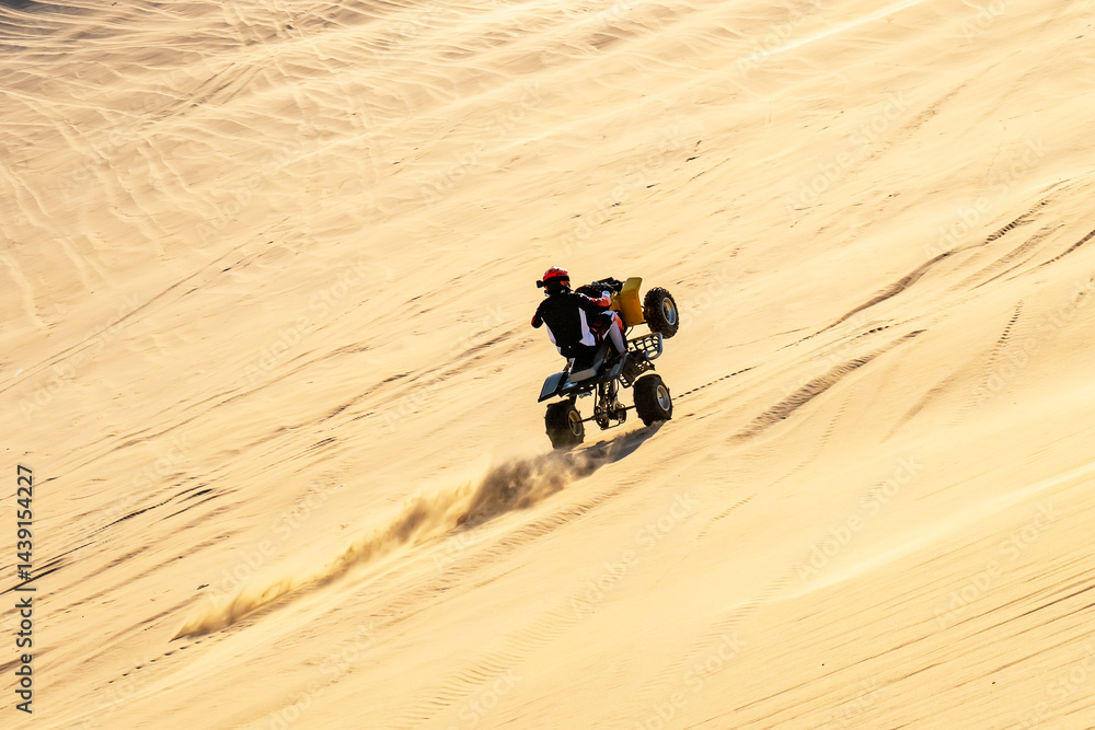 ATV is traveling through the desert at high speed.