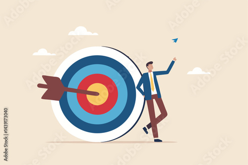 Business objective, purpose or target, goal and resolution to aim for success, aspiration and motivation to achieve goal concept, confident businessman stand with arrow hit bullseye on archery target.