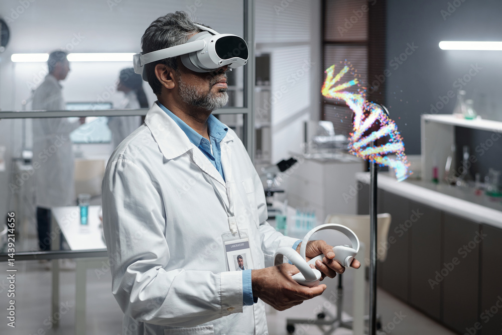 Middle-aged scientist interacting with virtual reality goggles in modern lab setting showing floating DNA helix fragment for research purposes
