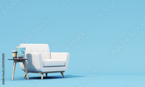 Comfortable armchair next to a small table with popcorn, coffee, and 3D glasses, creating a cozy home cinema vibe against a soft blue background. 3d rendering.