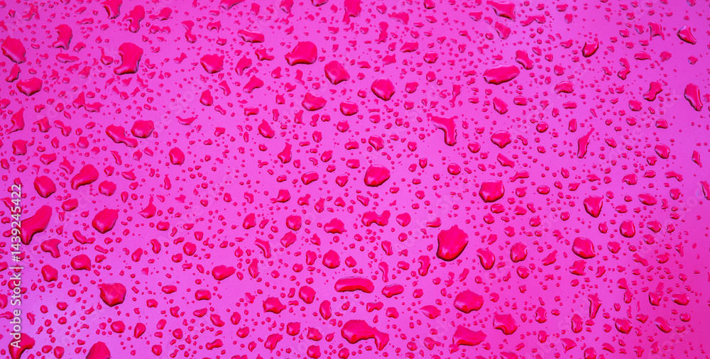 wide red purple background with the texture of rain drops on metal surface closeup wide red purple background with the texture of rain drops on metal surface closeup