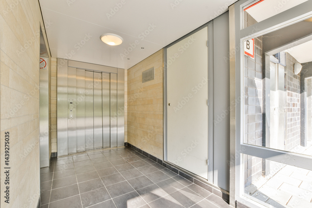 Obraz premium A sleek, modern indoor elevator lobby featuring smooth surfaces, minimalist design, and bright lighting that creates an inviting atmosphere.