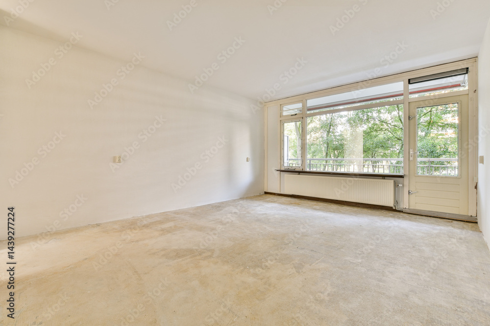 Fototapeta premium A spacious, empty interior showcasing large windows that invite natural light, creating a serene atmosphere perfect for customization.
