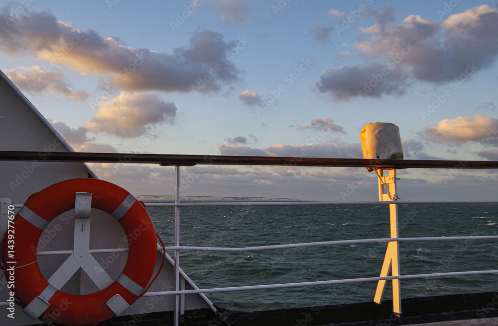 Beautiful breathtaking sunset blue hour twilight panorama at sea with dramatic sky seen from outdoor deck of classic cruiseship cruise ship liner sailing on ocean