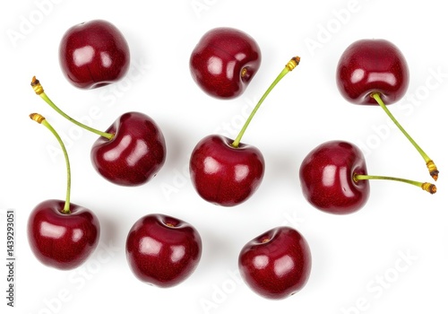 Isolated arrangement of eight ripe cherries with stems on a plain white surface in a top down view