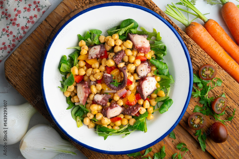 Salpicon de pulpo. Octopus salad with chickpeas, arugula and vegetables. Top view table. Salpicon de pulpo. Octopus salad with chickpeas, arugula and vegetables. Top view table.