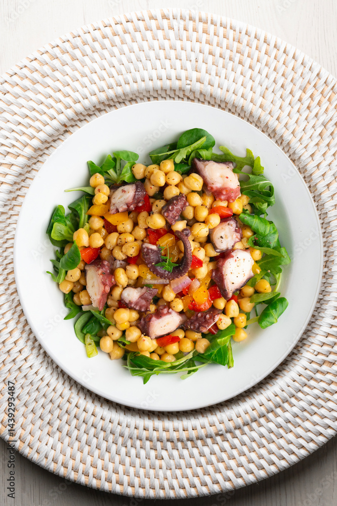 Salpicon de pulpo. Octopus salad with chickpeas, arugula and vegetables. Top view table. Salpicon de pulpo. Octopus salad with chickpeas, arugula and vegetables. Top view table.