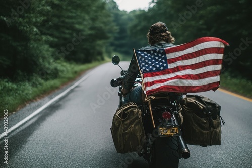 A woman is riding a motorcycle with an American flag on the back
