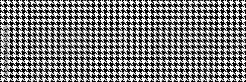 Classic black and white houndstooth pattern.  Seamless texture ideal for textile design, fashion, or website backgrounds.