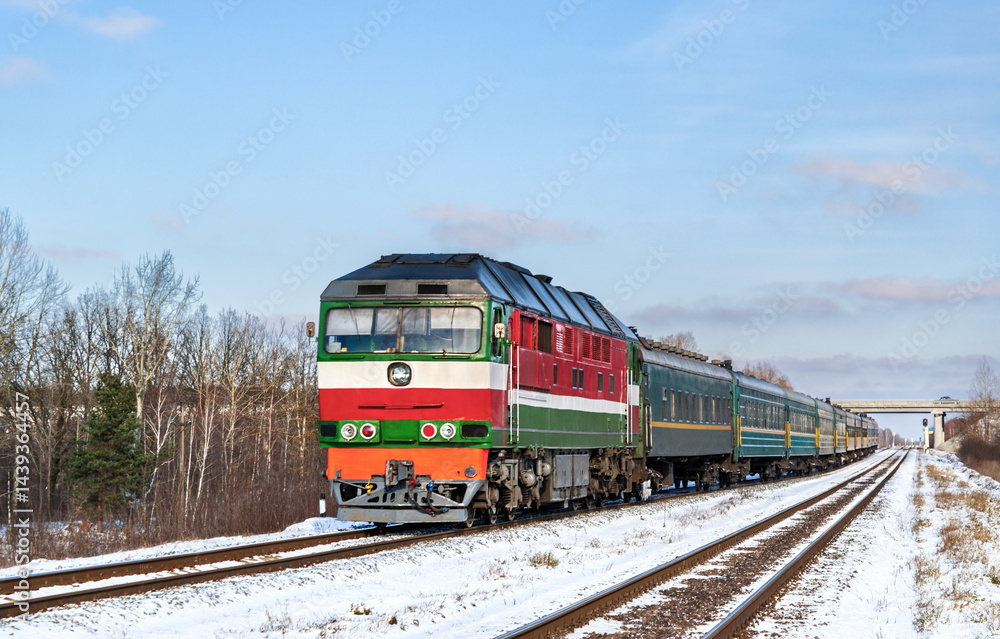 Belarusian locomotive with a Russian train in winter in Ukraine