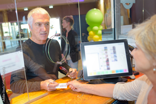 Obraz na płótnie man holding or showing two cinema tickets booking ticket concept w salonie