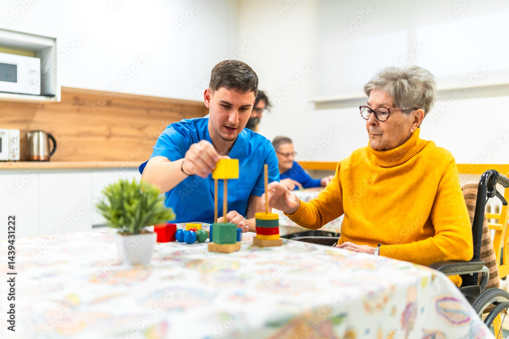 Nurse assisting elderly woman playing with building blocks in nursing home
