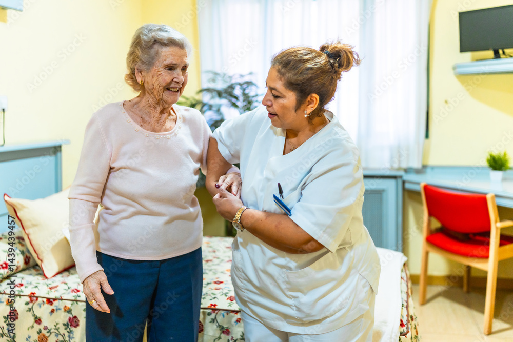 Nurse assisting elderly woman in nursing home