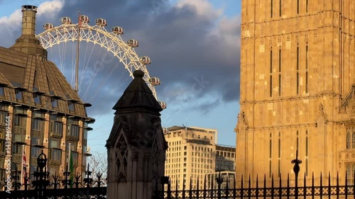 Big Ben in the heart of Westminster in London, England illuminated at dusk, golden glow against a dramatic sky