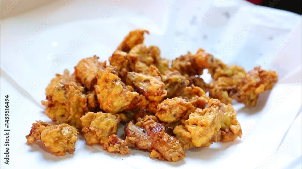Fried chicken being prepared in a kitchen Fried chicken being prepared in a kitchen