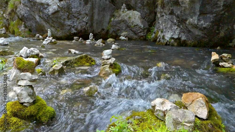 water flowing from the rocks, stones stacked in balance in a mountain river, 4k, slow motion water flowing from the rocks, stones stacked in balance in a mountain river, 4k, slow motion