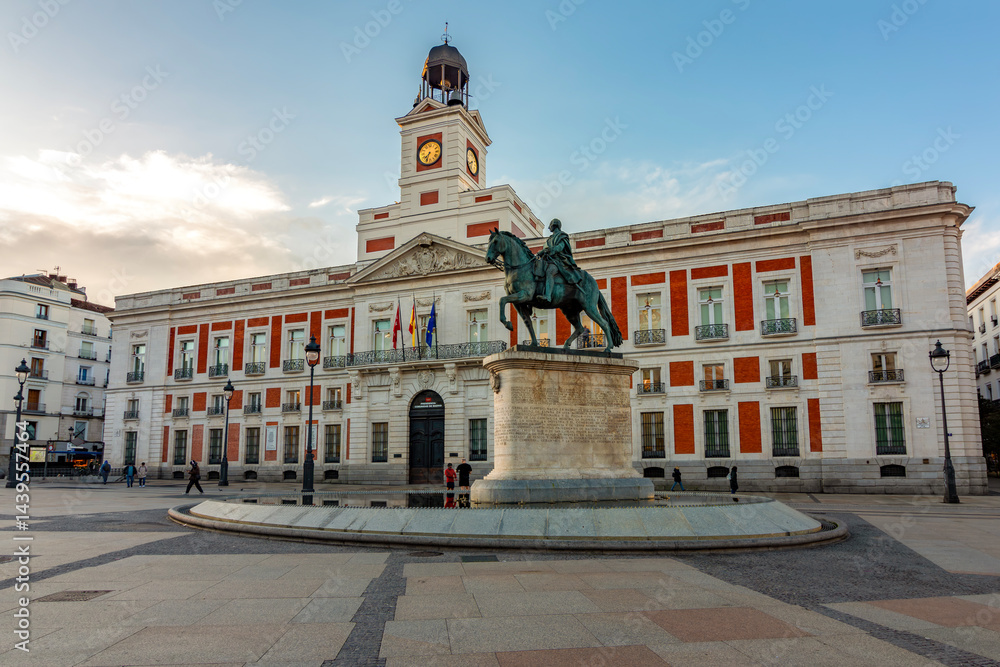 Naklejka premium Post office building and statue of king Charles III on Puerta del Sol square, Madrid, Spain
