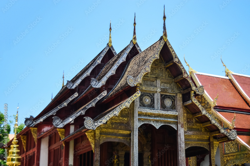 Naklejka premium Golden Pagoda and Chapel, Lanna Architecture, Symbols of Buddhism, South East Asia at Wat Phra Singh Woramahaviharn, Chiang Mai, Northern Thailand