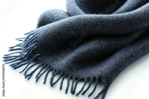 Soft navy blue scarf with fringes placed on a light background for a cozy look