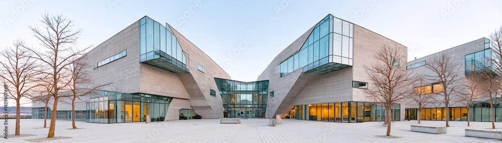 Fototapeta premium Minimalist architecture, modern structure, sharp lines, concrete and glass, dramatic lighting, symmetrical balance, urban aesthetics, fine details, high-resolution, professional photography