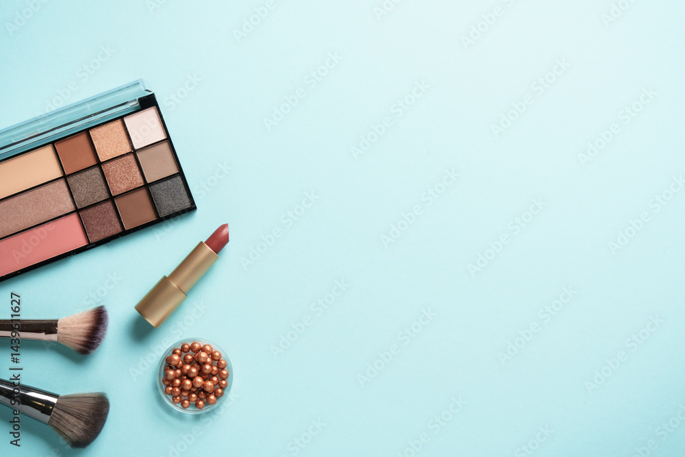 Cosmetic palette, brushes and lipstick. Flat lay with copy space.