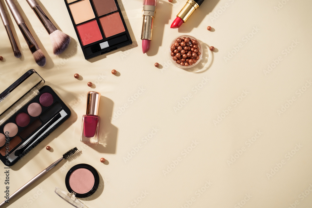 Make up products at colored background with hard shadows. Top view image with copy space.