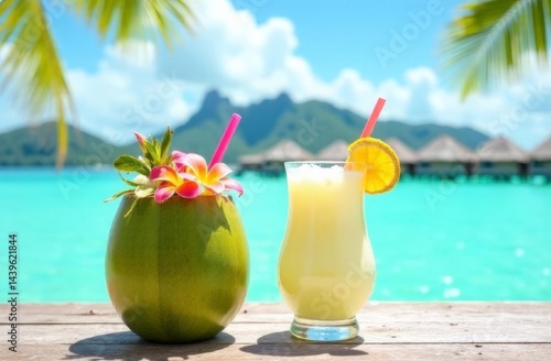 coconut with milk decorated with flowers and a glass of cocktail against the ocean