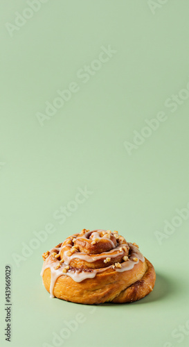 Single Cinnamon Roll, Appetizing, Isolated, on Light Green Background with Copy Space