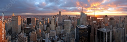 New York City Skyline at Sunset. Aerial view of the iconic skyscrapers and city. Possible use Background for business presentations, travel magazines, or desktop wallpaper