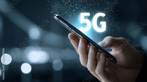 Obraz na płótnie 5G Technology at Fingertips: A person's hand holds a smartphone displaying a bright 5G symbol. This image highlights the cutting-edge of mobile communication. w salonie