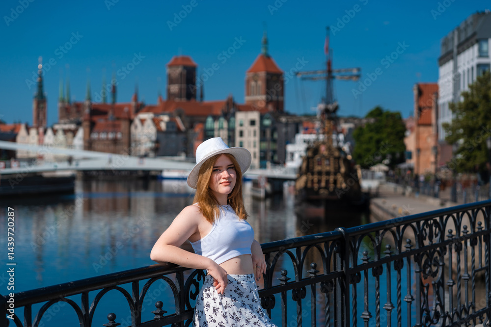 girl in a white hat on the background of the city of Gdansk Poland Europe