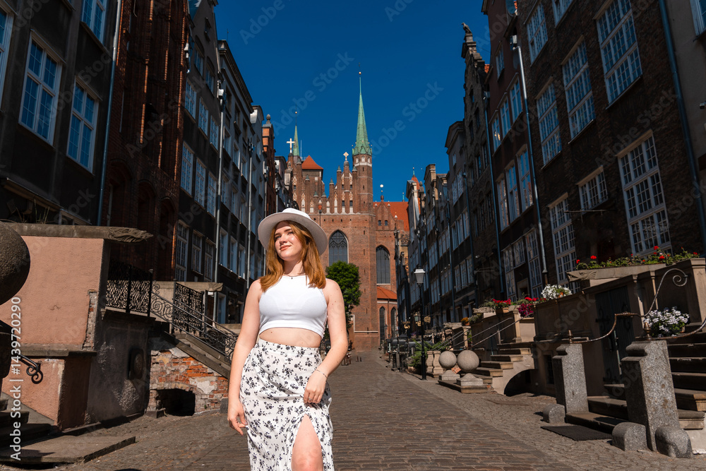 girl in a white hat on the background of the city of Gdansk Poland Europe