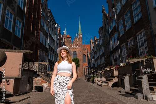 Obraz na płótnie girl in a white hat on the background of the city of Gdansk Poland Europe w salonie