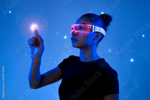 Woman interacting with a holographic interface wearing VR glasses in a futuristic setting