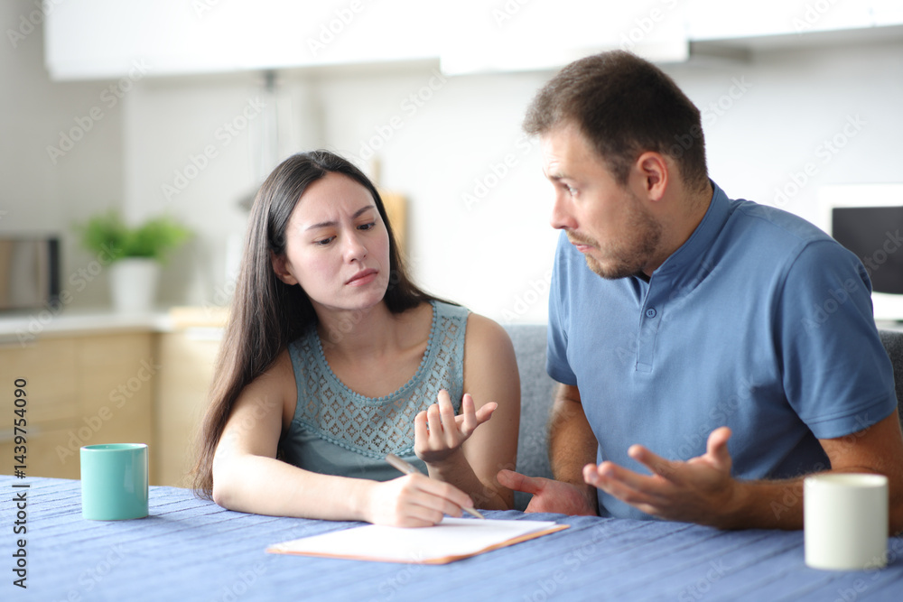 Fototapeta premium Angry woman asking for explanation to her confused partner