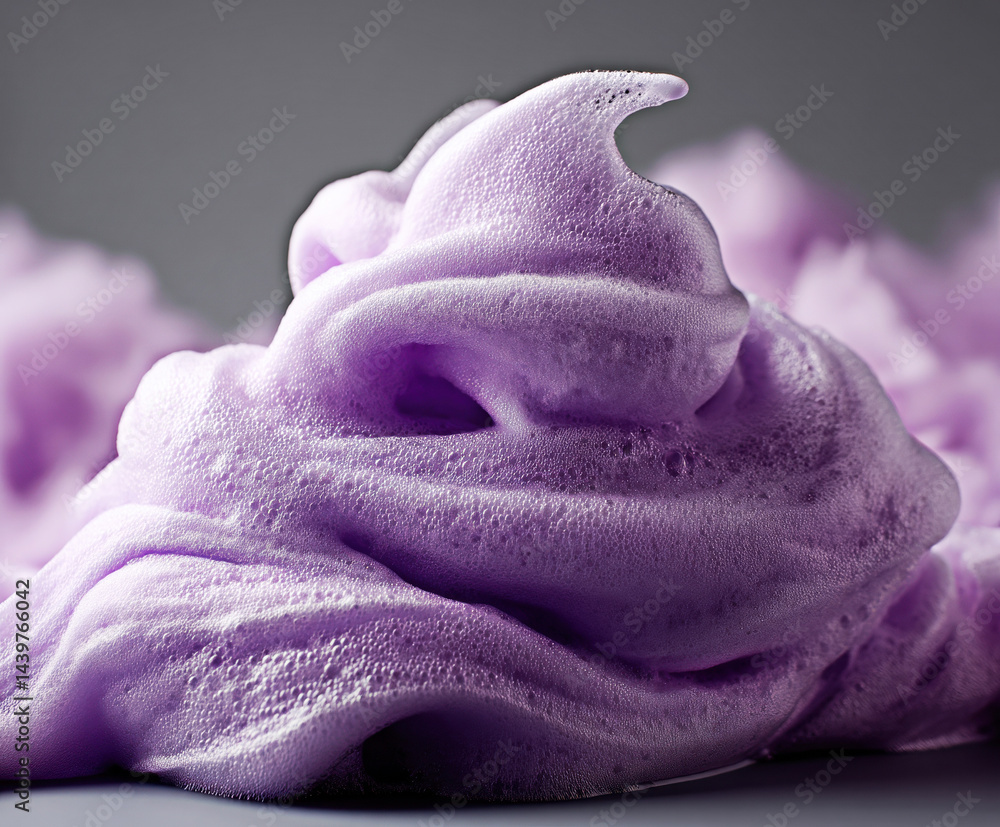 This captivating image showcases a swirl of lavender foam, highlighting the textures and bubbles that create a soothing and dreamy visual experience, perfect for relaxation and mindfulness themes.