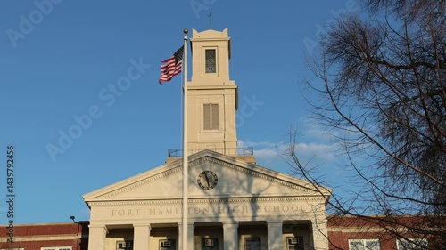fort hamilton high school entrance sign in bay ridge brooklyn new york city (public education student graduation) sunset glow building exterior facade american flag america usa