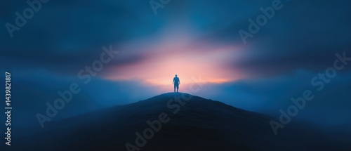 Man silhouette atop misty hill