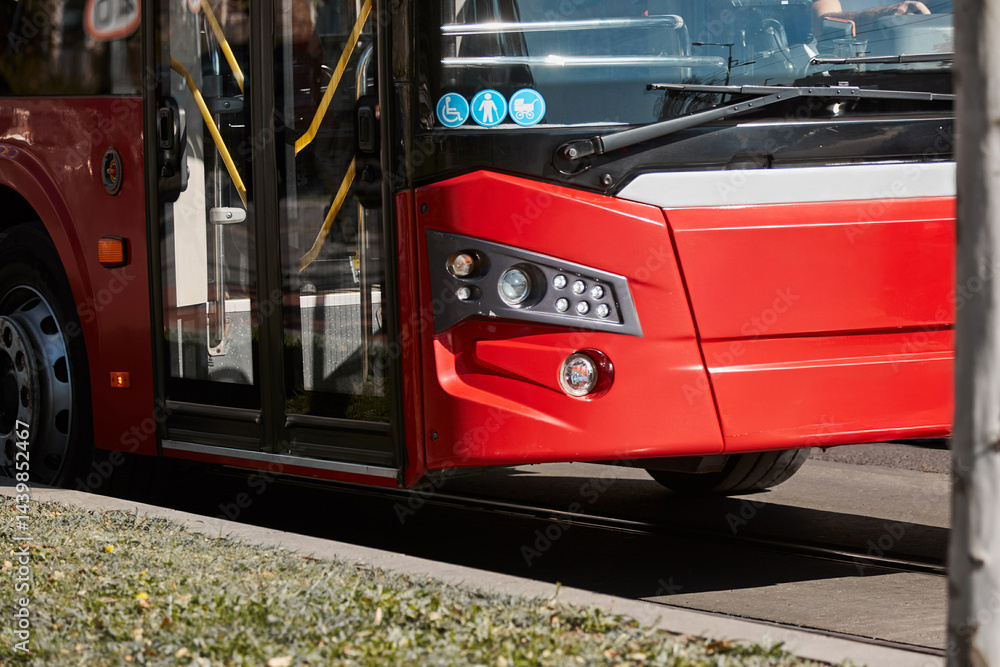 Red bus for public transportation on city streets.