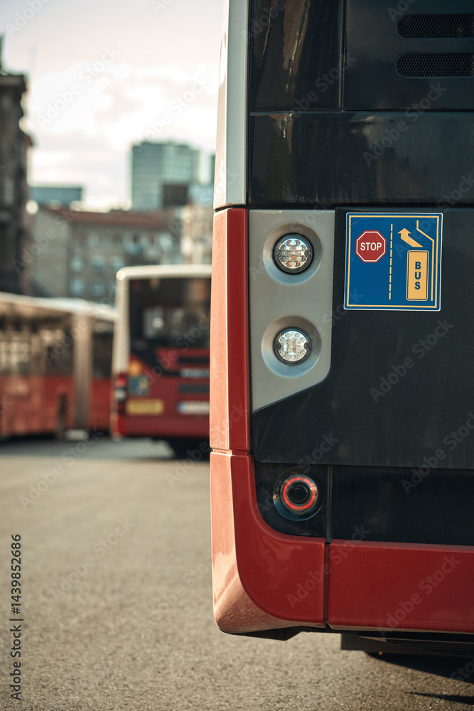 Red bus for public transportation parked on a station.