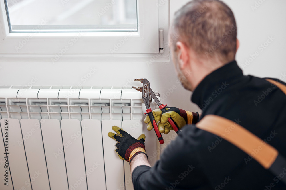 Central heating mechanic and handyman fixing home radiator, gas crisis and seasonal issues.