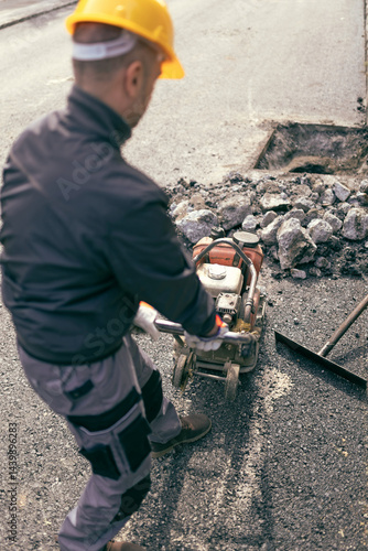 Construction worker working on a public city road reconstruction