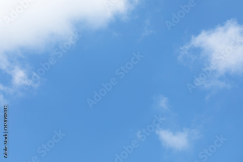 Obraz na płótnie Blue sky background and white clouds soft focus, space in the middle, horizontal shape. w salonie