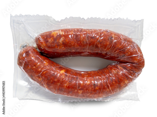 Vacuum-sealed spicy chili sausage isolated