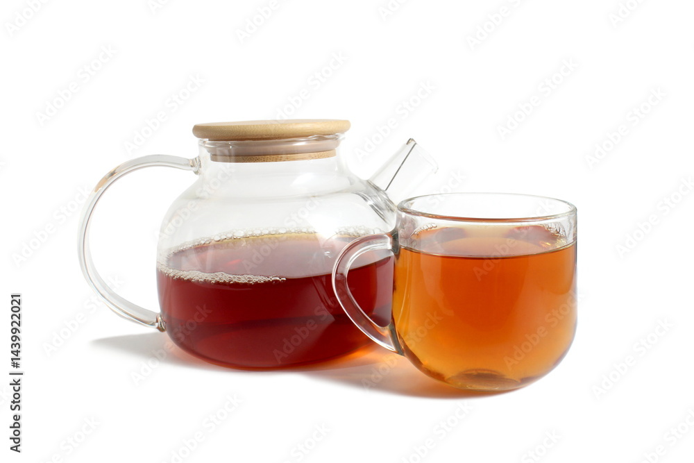 There is a glass teapot with tea on a white background. There is a glass teapot with tea on a white background.