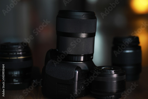 Obraz na płótnie Professional Camera With Interchangeable Lenses on Wooden Surface in Studio Lighting w salonie