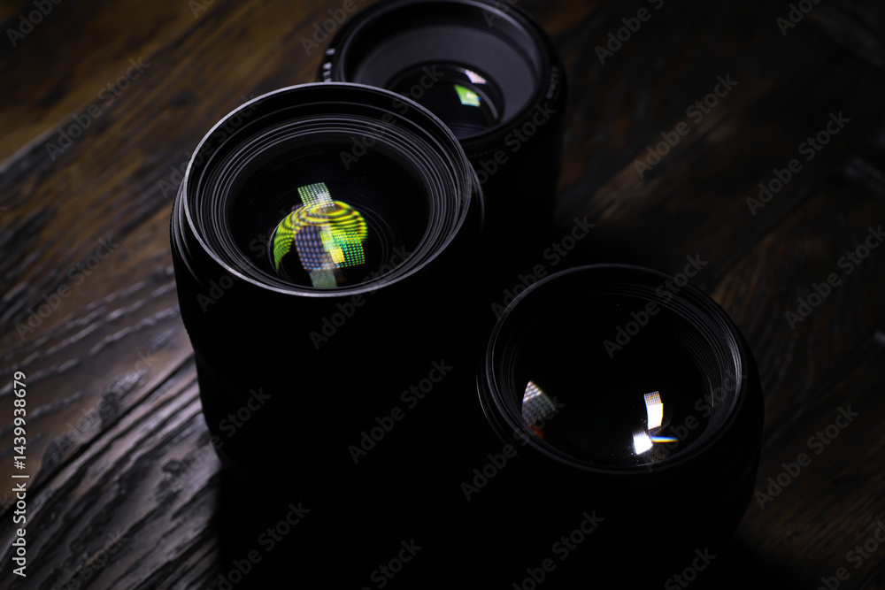 Close-Up of Camera Lenses with Reflections on Wooden Surface
